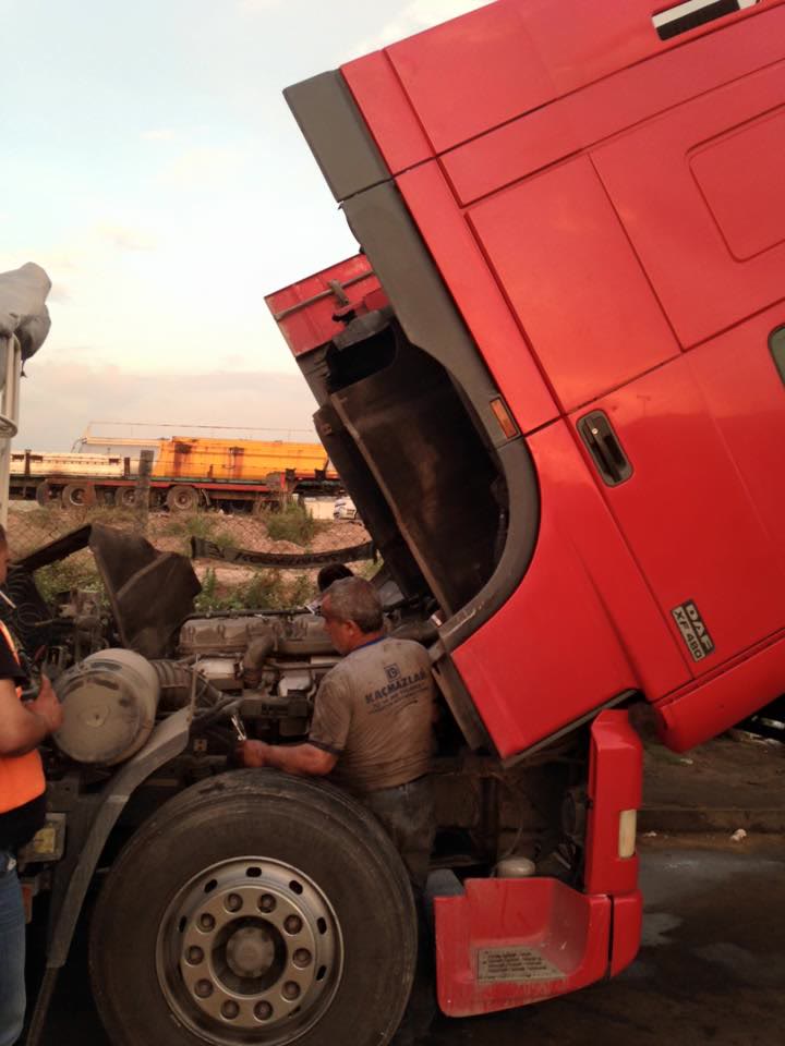 Kabini kaldırılmış kırmızı çekicide motor üzerinde çalışma